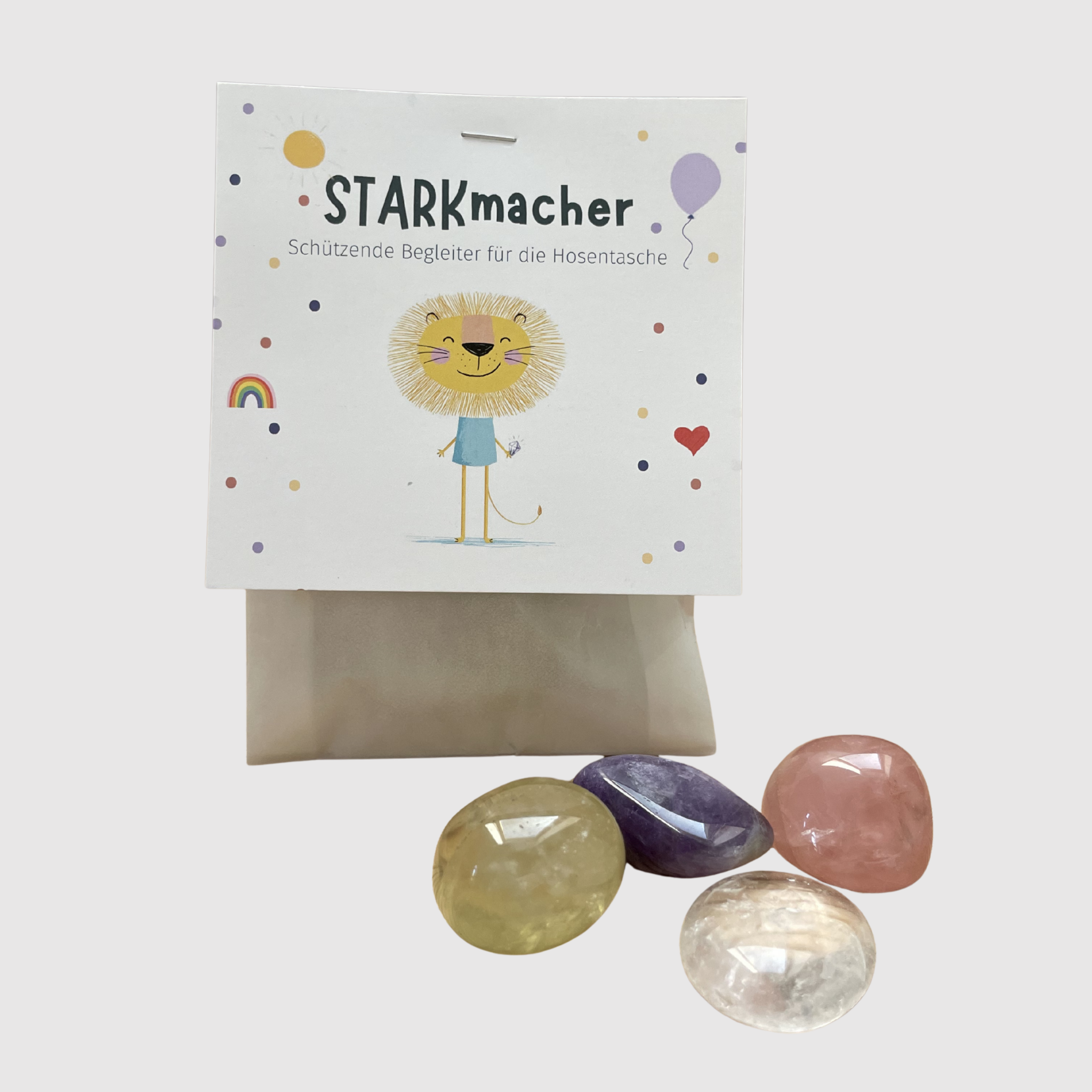 STARKmacher Set Verpackung mit Löwen-Illustration und vier schützenden Kristallen für die Hosentasche